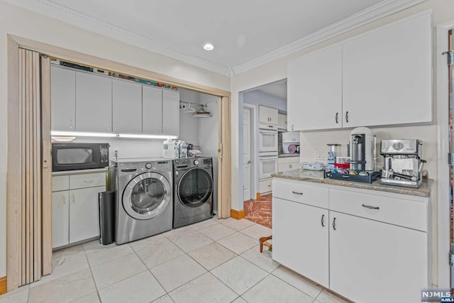 laundry room featuring separate washer and dryer and crown molding