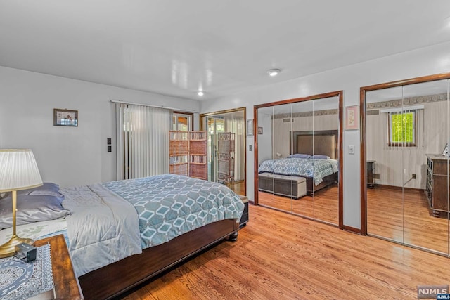 bedroom featuring multiple closets and hardwood / wood-style flooring