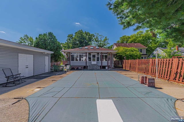 exterior space featuring a patio and a covered pool