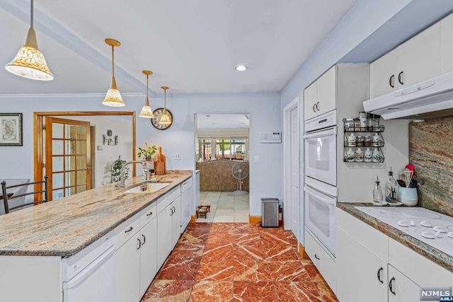 kitchen with sink, white cabinets, pendant lighting, and white appliances