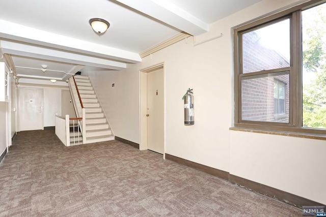 basement with dark carpet and a wealth of natural light