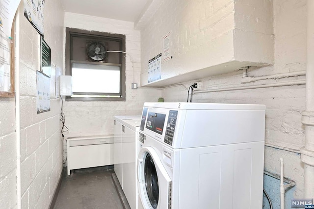 clothes washing area featuring separate washer and dryer