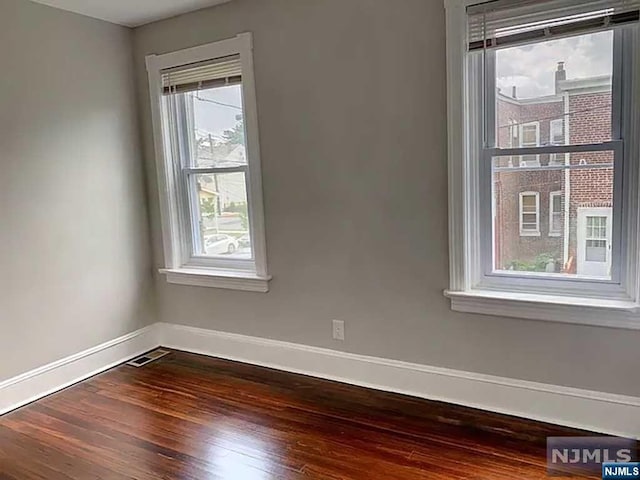 empty room with dark hardwood / wood-style floors