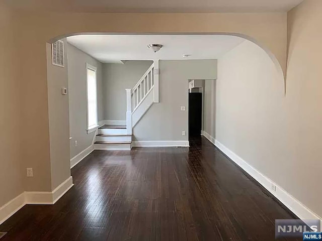 empty room featuring dark wood-type flooring