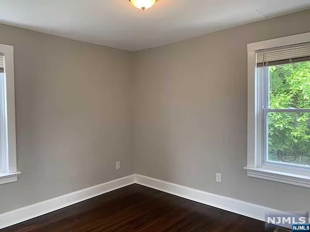 empty room with hardwood / wood-style floors