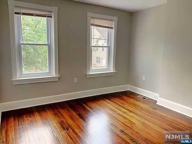 empty room with wood-type flooring