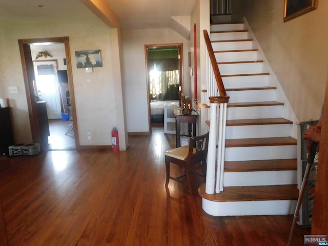 staircase with hardwood / wood-style flooring