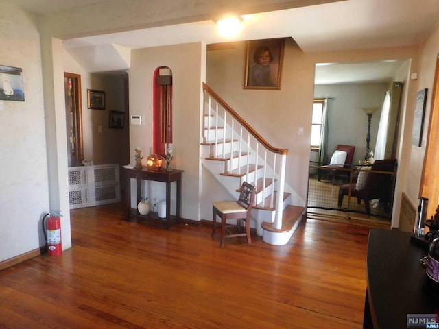 interior space with radiator and hardwood / wood-style flooring