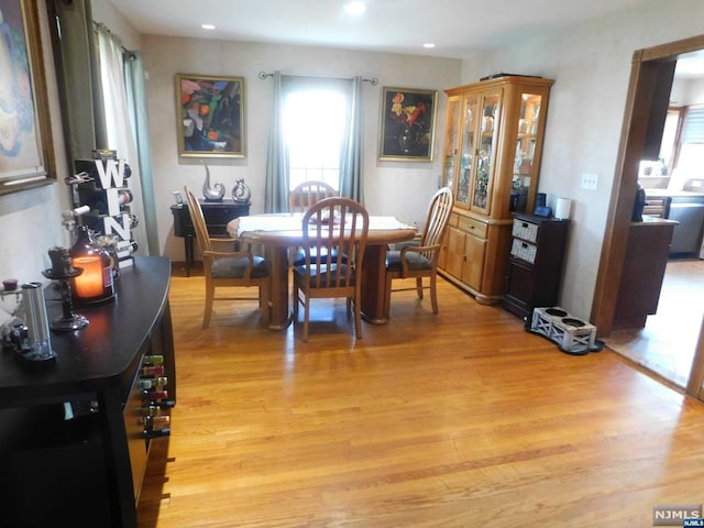 dining space with light hardwood / wood-style flooring