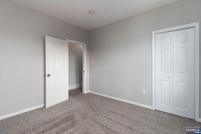 unfurnished bedroom with carpet floors and a closet