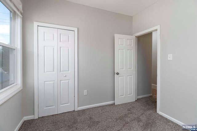 unfurnished bedroom with a closet and carpet