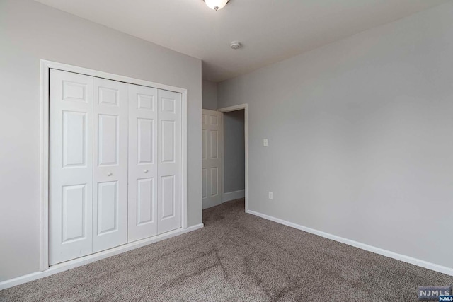 unfurnished bedroom with carpet floors and a closet