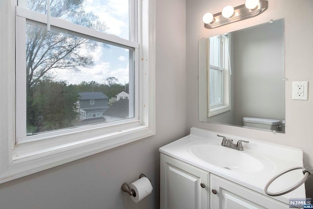 bathroom featuring vanity and toilet