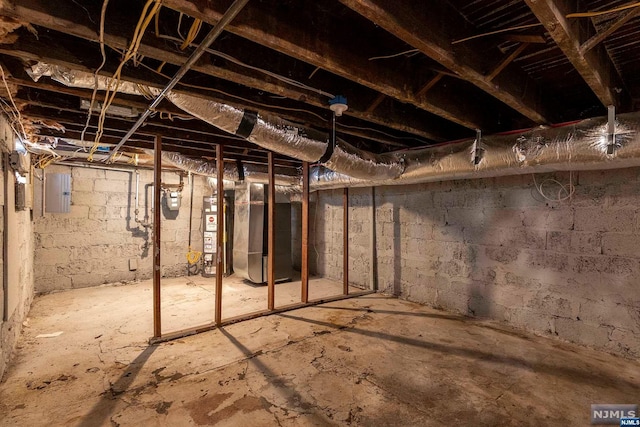 basement with electric panel and water heater