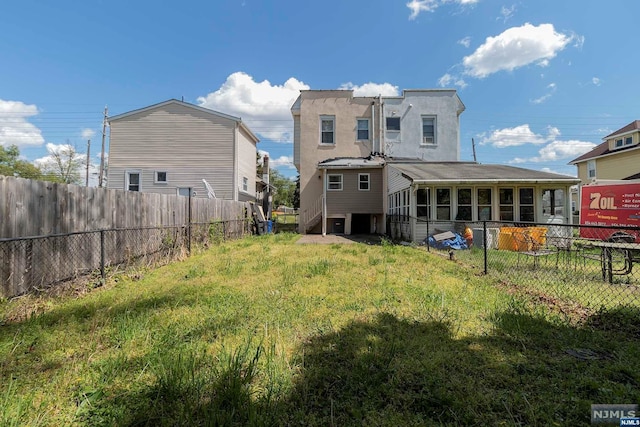 rear view of property featuring a yard