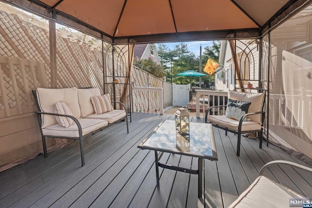 deck featuring a gazebo and outdoor lounge area