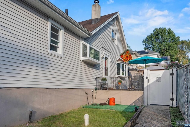 view of side of property with a yard