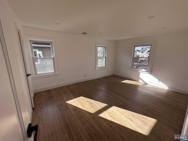 spare room with dark wood-type flooring