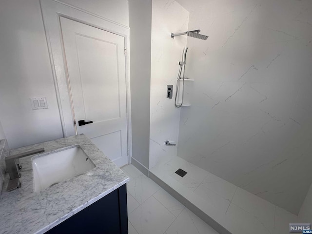 bathroom featuring walk in shower and vanity