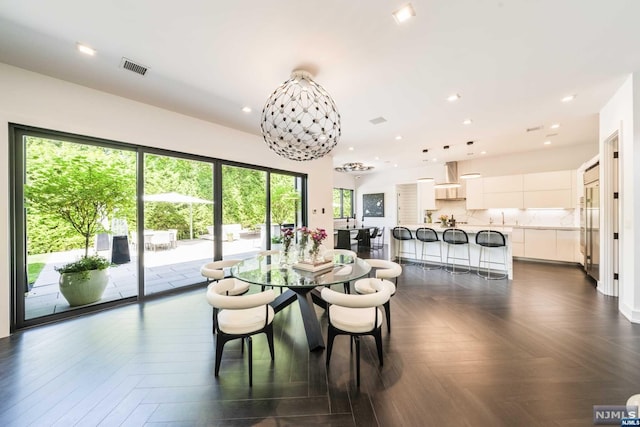 dining room featuring dark parquet floors and a notable chandelier