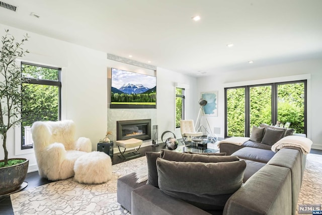 living room with a fireplace, hardwood / wood-style flooring, and plenty of natural light