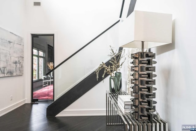 staircase with hardwood / wood-style flooring