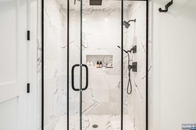 bathroom with a shower with shower door