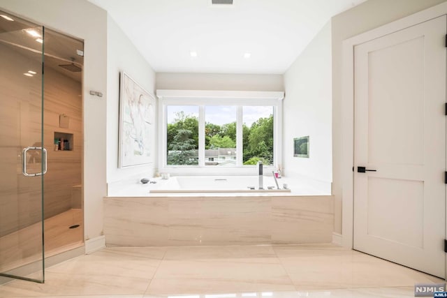 bathroom with tile patterned floors and plus walk in shower