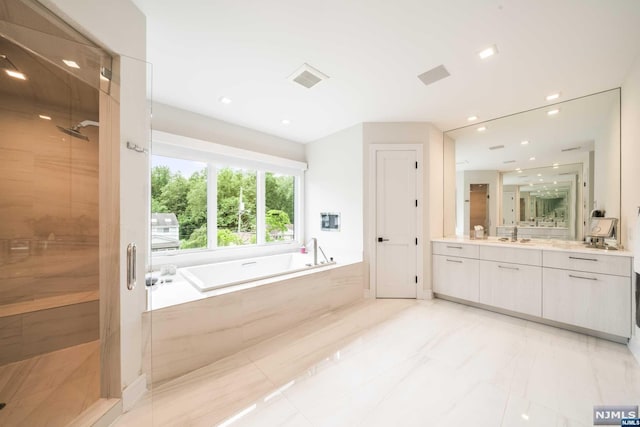 bathroom featuring plus walk in shower and vanity