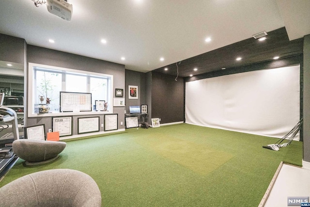 recreation room with carpet floors and golf simulator