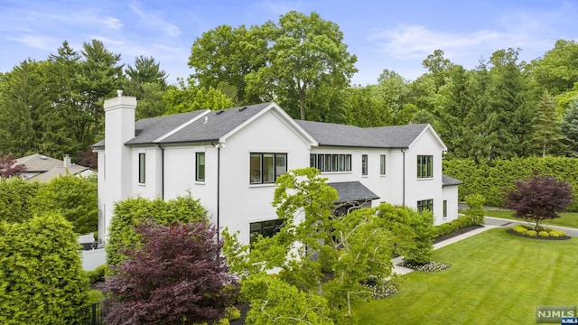 rear view of house with a yard