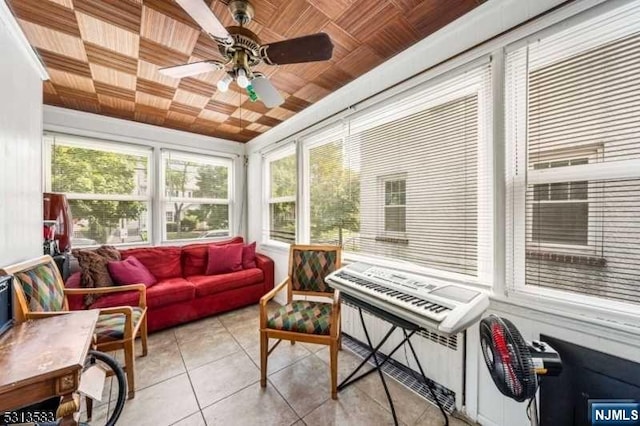 sunroom / solarium with ceiling fan and wooden ceiling