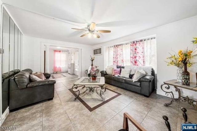 tiled living room featuring ceiling fan