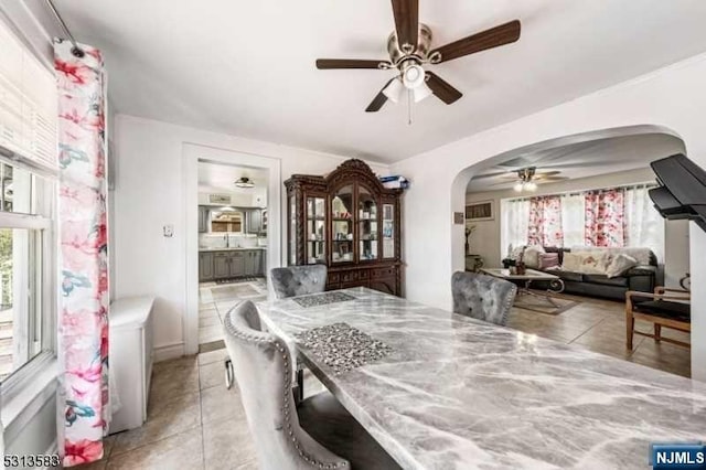 tiled dining area featuring ceiling fan