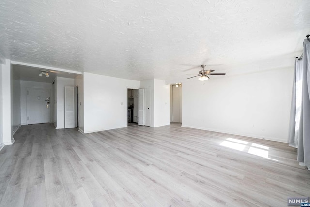 unfurnished living room featuring ceiling fan, light hardwood / wood-style floors, and a textured ceiling