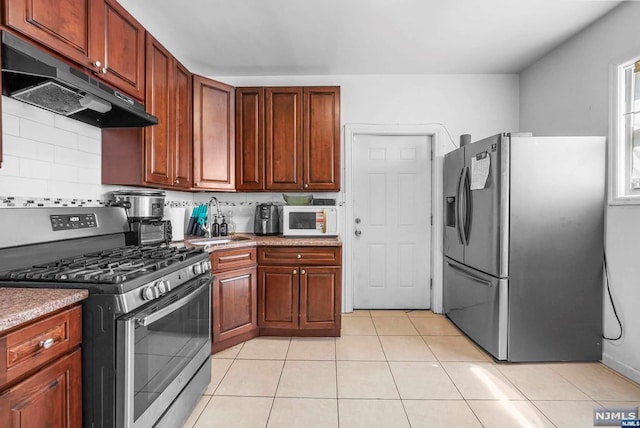 kitchen with decorative backsplash, light tile patterned floors, sink, and appliances with stainless steel finishes