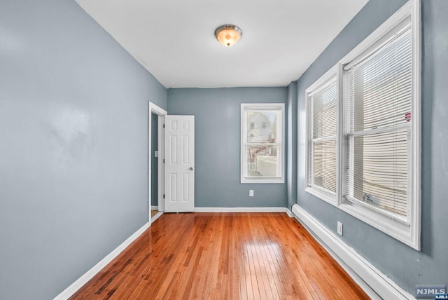 empty room with light hardwood / wood-style flooring