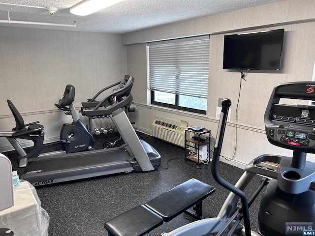 workout room featuring a textured ceiling