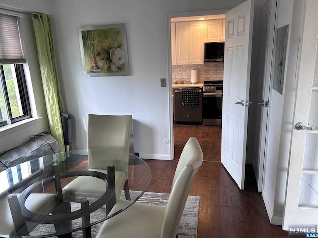 dining room with dark hardwood / wood-style flooring and electric panel