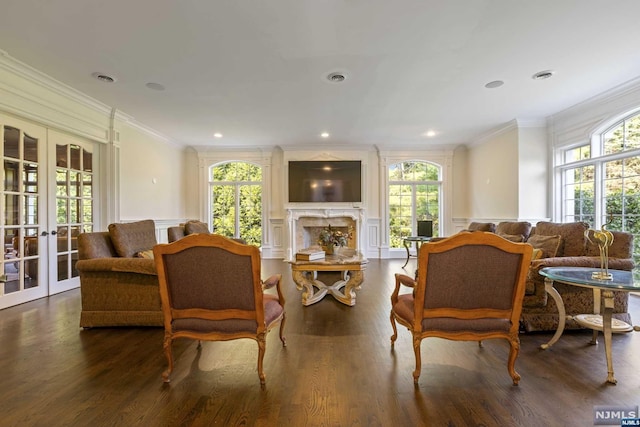 living room featuring french doors, dark hardwood / wood-style floors, a wealth of natural light, and crown molding