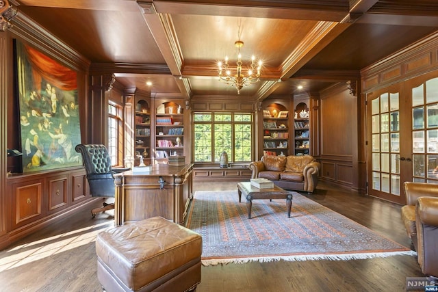 sitting room with dark hardwood / wood-style floors, an inviting chandelier, built in features, and coffered ceiling