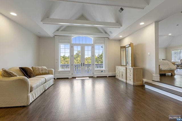 living room featuring lofted ceiling with beams, dark wood-type flooring, and a baseboard heating unit