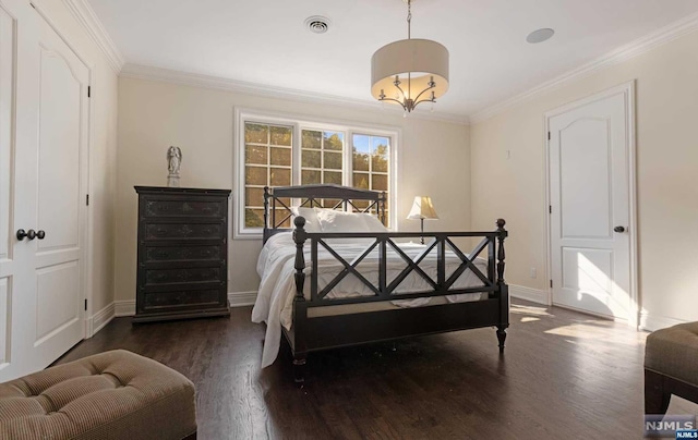 bedroom with dark hardwood / wood-style floors and ornamental molding