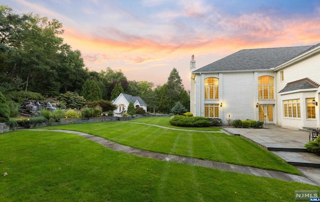 yard at dusk with a patio