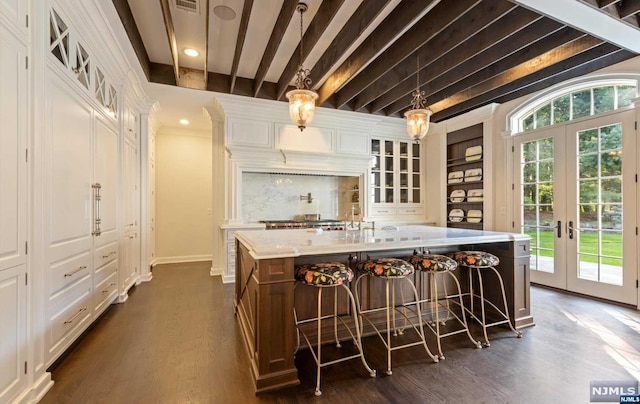 bar with beamed ceiling, dark hardwood / wood-style floors, white cabinets, and french doors