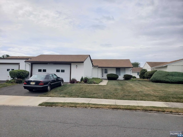 single story home featuring a garage and a front yard