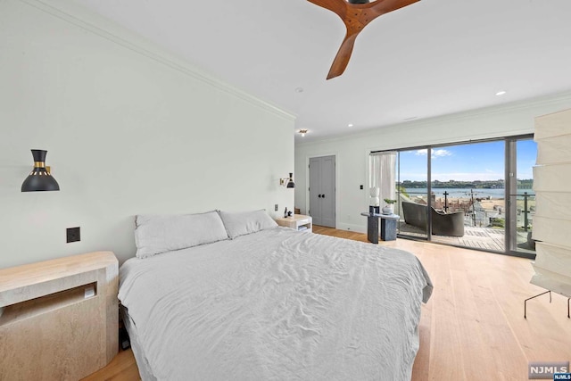 bedroom featuring a water view, crown molding, ceiling fan, access to exterior, and light wood-type flooring