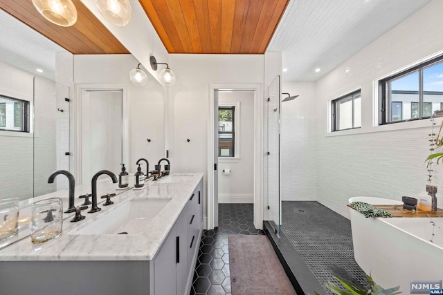 bathroom featuring tile patterned flooring, vanity, a healthy amount of sunlight, and independent shower and bath