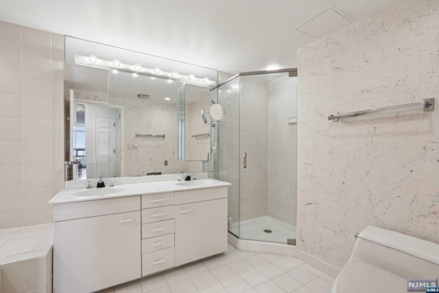 bathroom featuring tile patterned flooring, vanity, an enclosed shower, and toilet