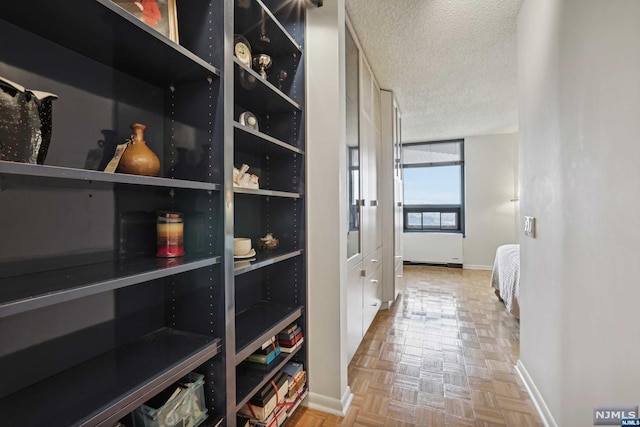 interior space with light parquet floors and a textured ceiling